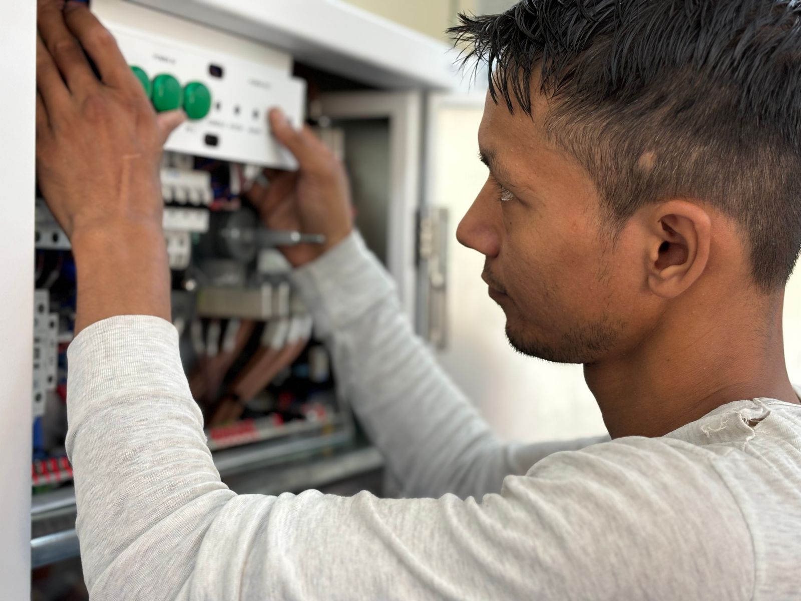 Electrician working on a circuit breaker panel