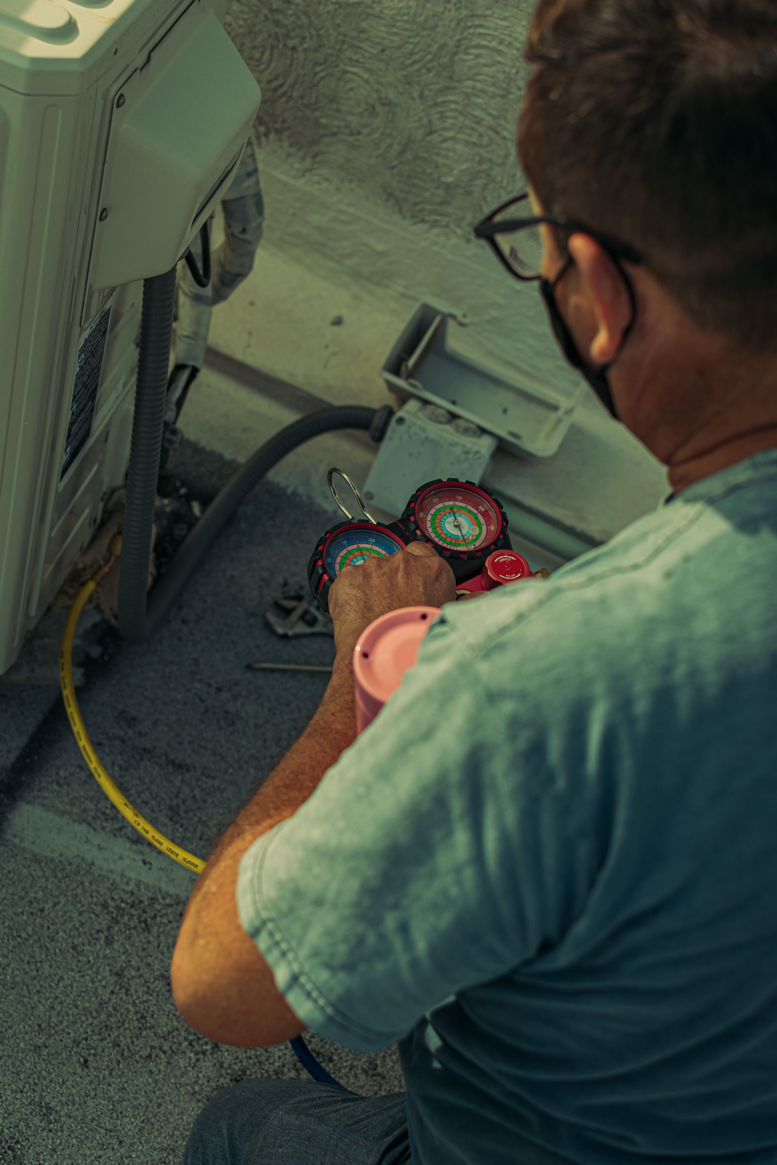 Technician servicing an outdoor air-conditioning unit