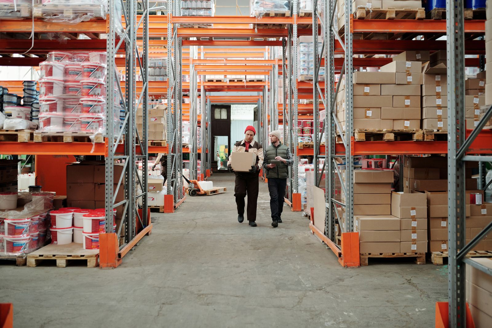 Staff checking stock in a supply warehouse